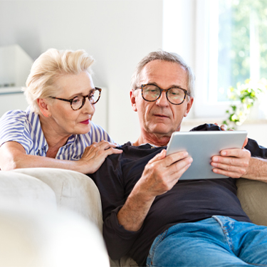 Protecting Your Personal Information Older couple looking at tablet together on couch